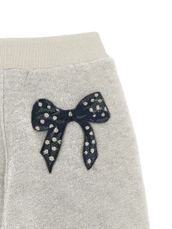 Jogger felpa glitter con fiocco
